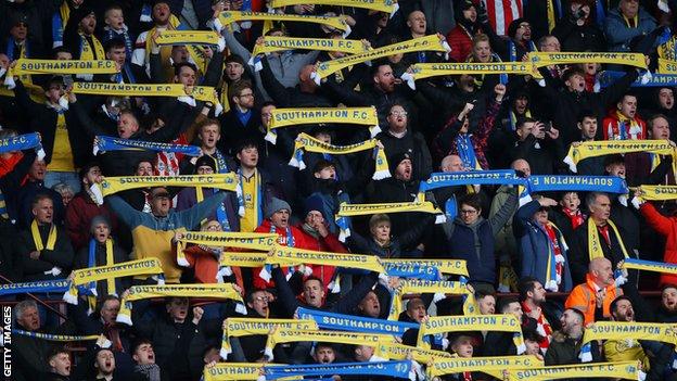 Southampton fans hold up yellow and blue scarves in support for Ukraine