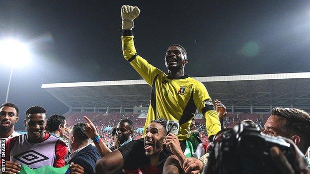 Equatorial Guinea players celebrate their penalty shoot-out win over Mali in the last 16
