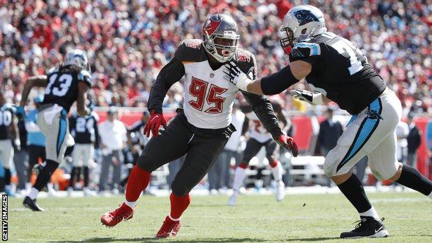 Tampa Bay Buccaneers defensive end Ryan Russell prepares to make a tackle against the Carolina Panthers in an NFL game