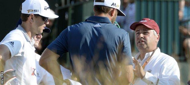 A course official spoke to Dustin Johnson at the fifth hole
