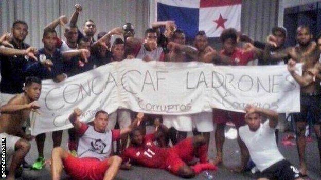 The Panama players pose with a banner that translates as "Concacaf thieves. Corrupt, corrupt, corrupt"