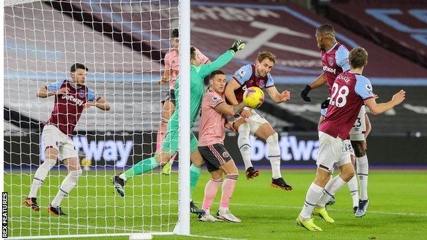 West Ham's Craig Dawson heads the ball clear of Sheffield United's Billy Sharp