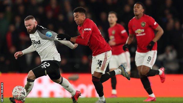 Jesse Lingard battles for possession with former Manchester United forward Wayne Rooney during the FA Cup fifth-round tie at Derby County on Thursday