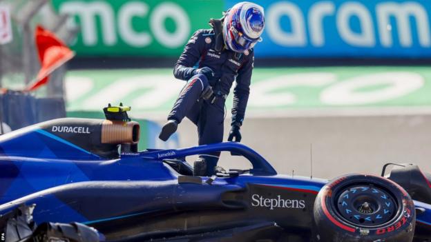 Logan Sargeant climbs out of his Williams after crashing out in Q3