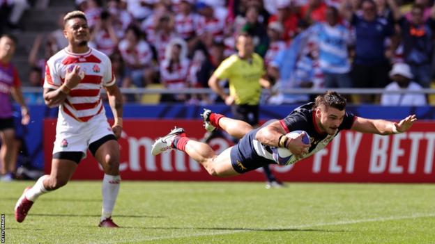 Matteo Carreras (right) dives over to score a try for Argentina against Japan