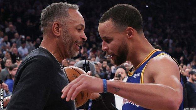 Curry hugs his father Dell after making the shot that gave him the NBA three-point record