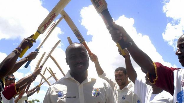 Brian Lara gets a guard of honour after scoring 400 against England
