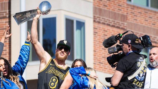 Cooper Kupp holding the Lombardi trophy during the Los Angeles Rams' trophy parade