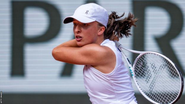 Iga Swiatek hits a return against Karolina Muchova in the French Open final