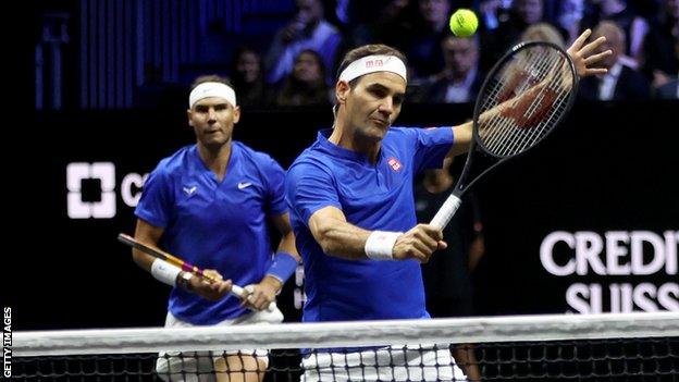 Roger Federer hits a volley in the final match of his career