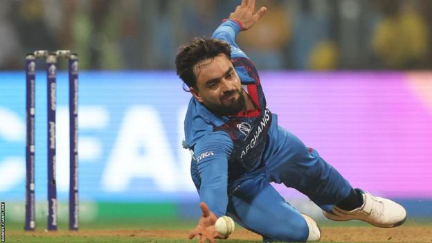 Rashid Khan diving to field a cricket ball