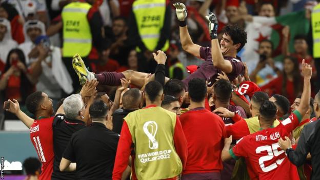 Morocco players celebrate victory after the World Cup win over Spain