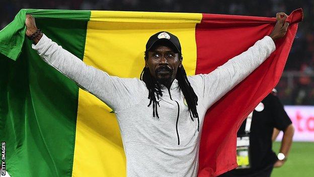 Senegal coach Aliou Cisse poses with the flag of his country