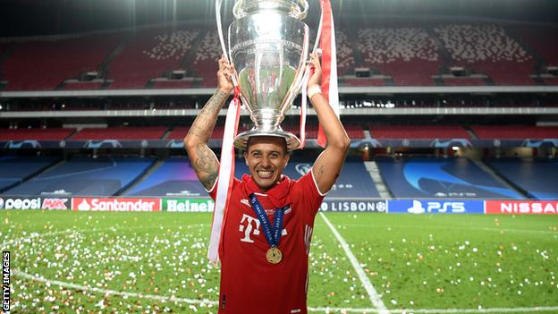 Thiago holds the Champions League trophy on his head