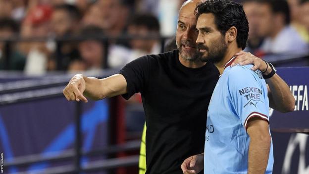 Manchester city manager Pep Guardiola with midfielder Ilkay Gundogan