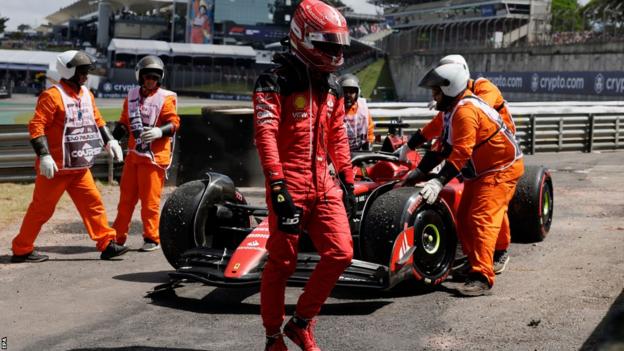 Ferrari's Charles Leclerc walks away from his car after crashing on the formation lap of the Sao Paulo Grand Prix