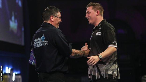 Gary Anderson shakes hands with Chris Dobey after winning their last 16 tie of the PDC World Championship at Alexandra Palace