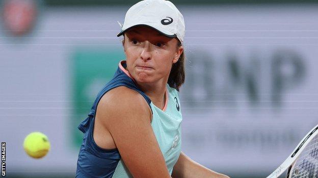 Iga Swiatek hits a return at the French Open