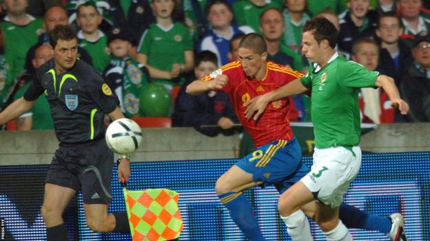Spain forward Fernando Torres is challenged by Jonny Evans, who was making his Northern Ireland debut in the 3-2 home win in 2006