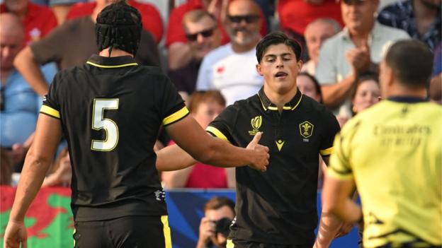 Dafydd Jenkins congratulates Louis Rees-Zammit of Wales after scoring a try during the World Cup game against Portugal
