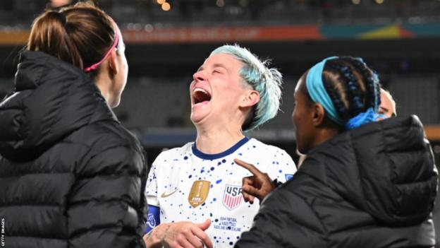 Megan Rapinoe (centre) reacts with team-mates aft  the United States gully  0-0 with Portugal astatine  the Fifa Women's World Cup