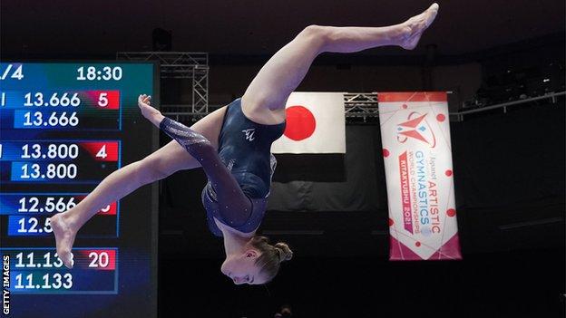 Ruby Stacey of Great Britain performs on the beam