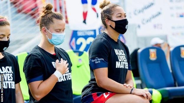 Kaiya McCullough and team-mates kneel while wearing Black Lives Matter T-shirts