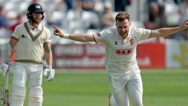 Essex bowler Sam Cook celebrates taking a wicket against Gloucestershire
