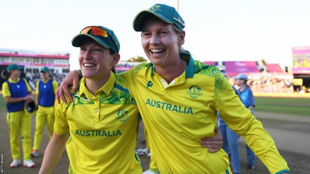 Megan Schutt (left) and Meg Lanning celebrate winning the Commonwealth Games for Australia bind