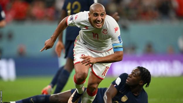 Tunisia's Wahbi Khazri wheels away in celebration after scoring against France