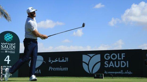 Dustin Johnson tees off on the fourth hole.