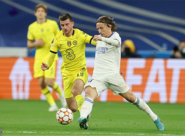 Real Madrid's Luka Modric, right, heads the ball past Manchester