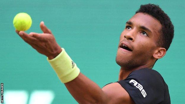 Felix Auger-Aliassime prepares to serve