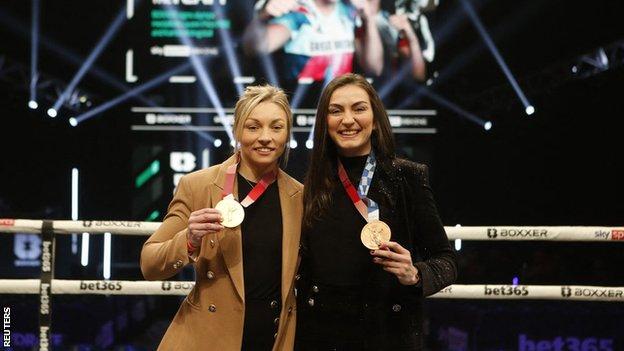 Lauren Price and Karriss Artingstall smile as they show off their Olympic medals