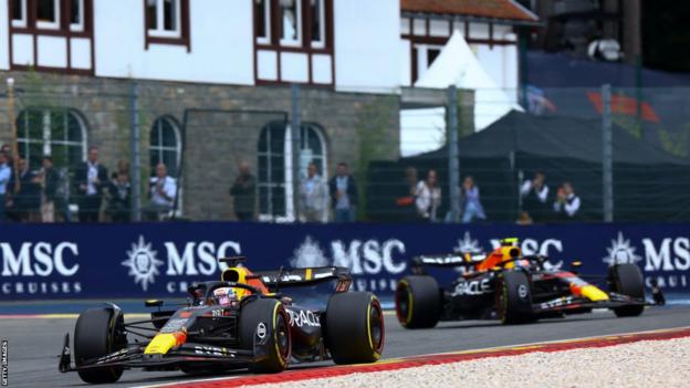 Max Verstappen runs up  of Red Bull team-mate Sergio Perez during the Belgian Grand Prix