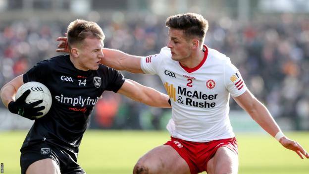 Rian O'Neill battles with Tyrone's Michael McKernan in last year's Division One contest at the Athletic Grounds