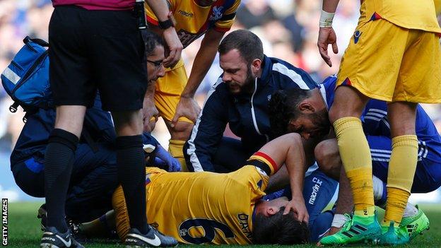 Scott Dann lies injured at Stamford Bridge