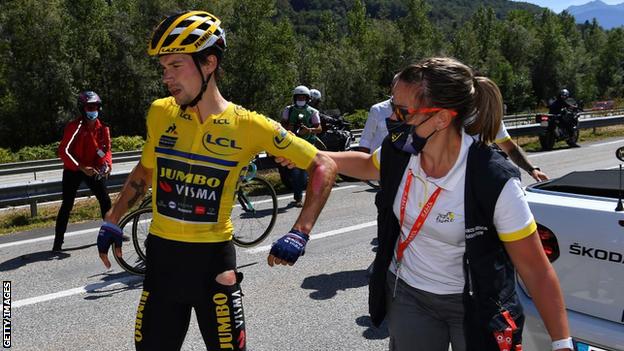 Primoz Roglic with a medic after his crash on Saturday