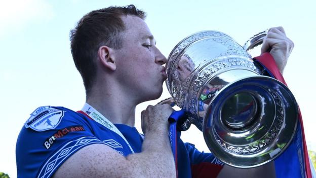 Northern Ireland's Shayne Lavery lifting the Gibson Cup with Linfield