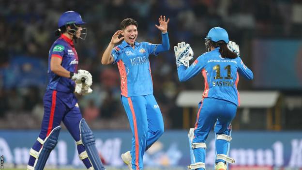 Issy Wong (middle) celebrates the wicket of Marizanne Kapp (left) with wicketkeeper Taniya Bhatia