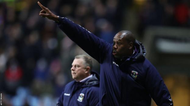 Coventry City first-team coach Dennis Lawrence barks out instructions, watched on by head coach Mark Robins