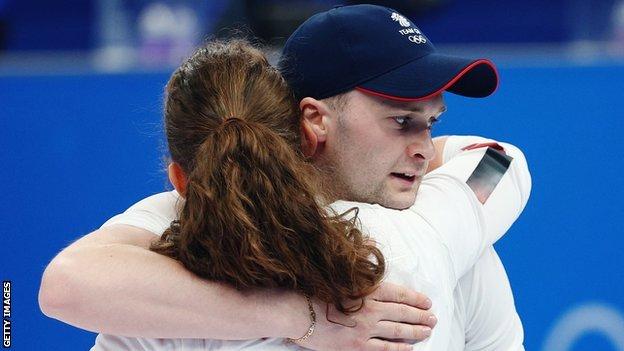 Bruce Mouat hugs Jenn Dodds