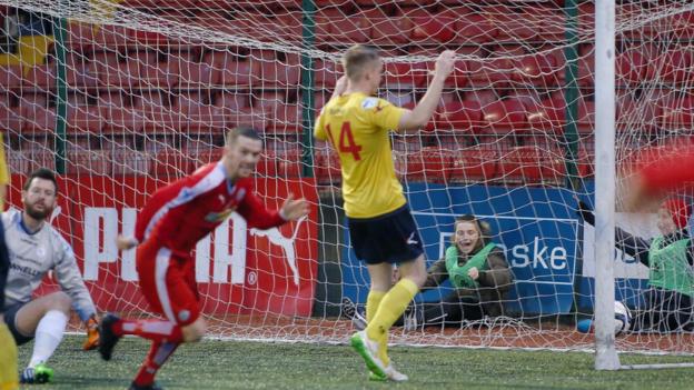Cliftonville winger Martin Donnelly scores the only goal in the win over Dungannon which moves the Reds to within five points of leaders Crusaders