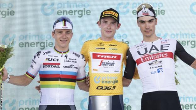 Third-placed Remco Evenepoel, winner Mattias Skjelmose and runner-up Juan Ayuso on the podium after the 2023 Tour de Suisse