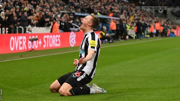 Newcastle midfielder Sean Longstaff celebrates a goal in front of the home fans