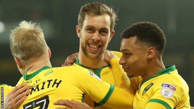Steven Whittaker (centre) celebrates scoring for Norwich