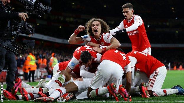 Arsenal players celebrate a goal against Newcastle on Sunday