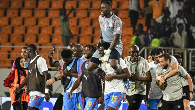 Lionel Mpasi is carried off by DR Congo team-mates after their penalty shoot-out win against Egypt