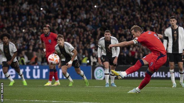 Harry Kane (right) scores for England