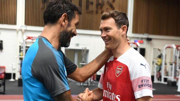 Stephan Lichtsteiner meets ex-Arsenal player Robert Pires at the club's training ground